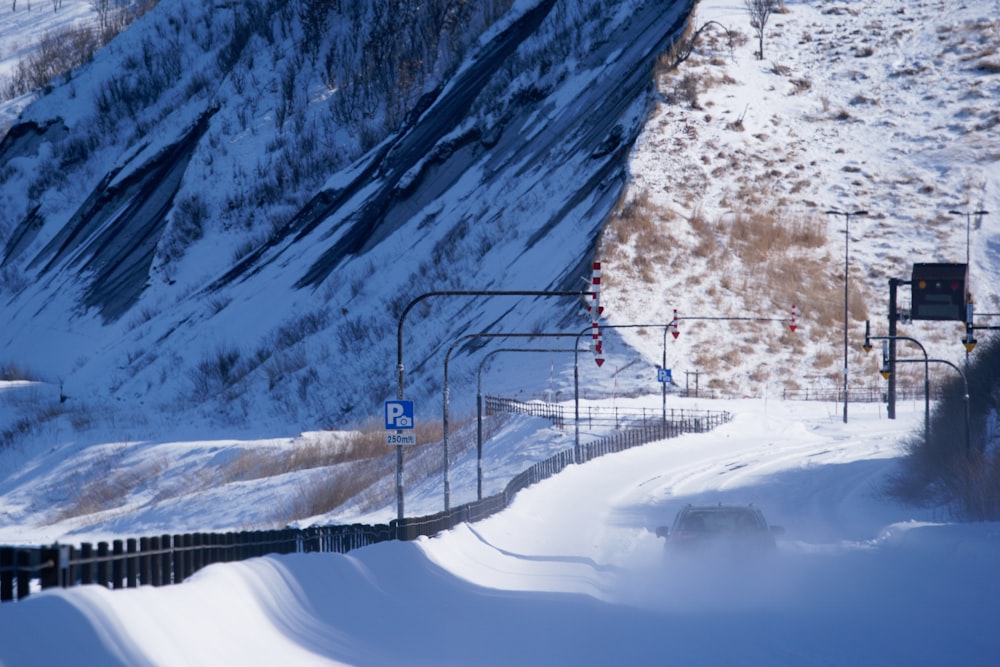 a train traveling through a snow covered mountain side