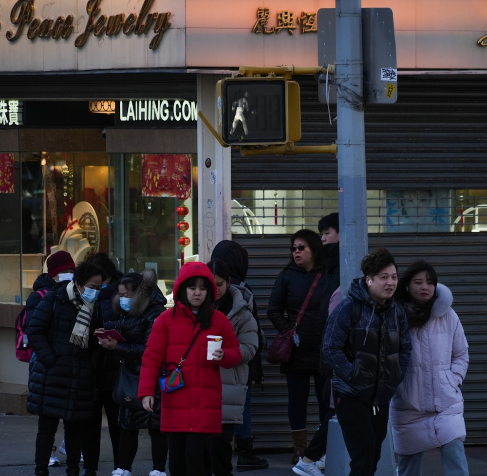 a group of people standing outside of a store