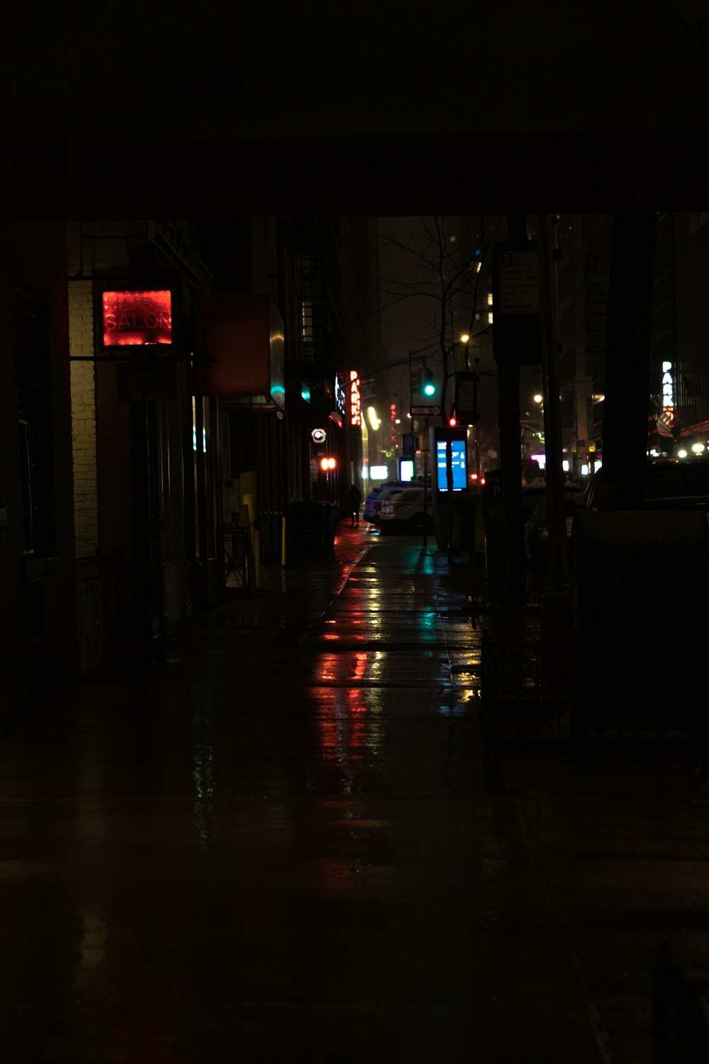 a city street at night with traffic lights