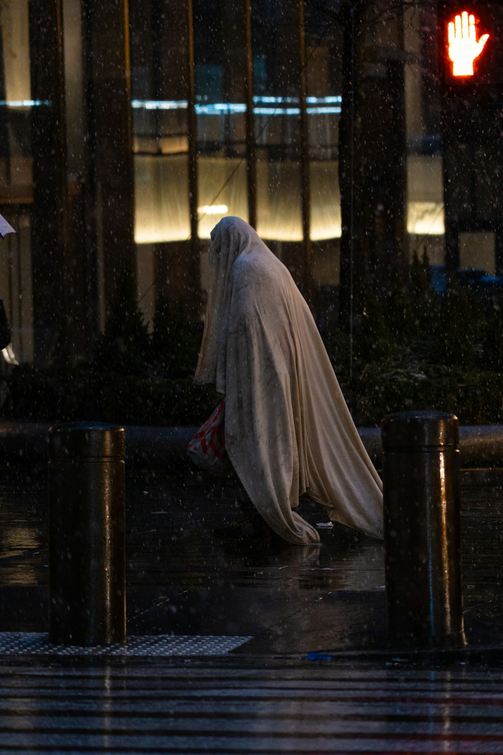 a person walking down a street holding an umbrella