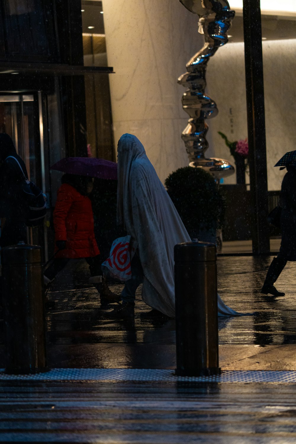 a group of people walking down a street holding umbrellas