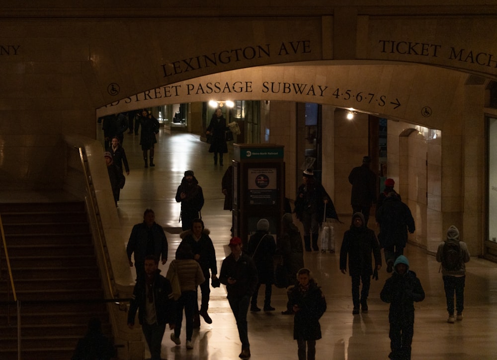 a group of people walking down a hallway