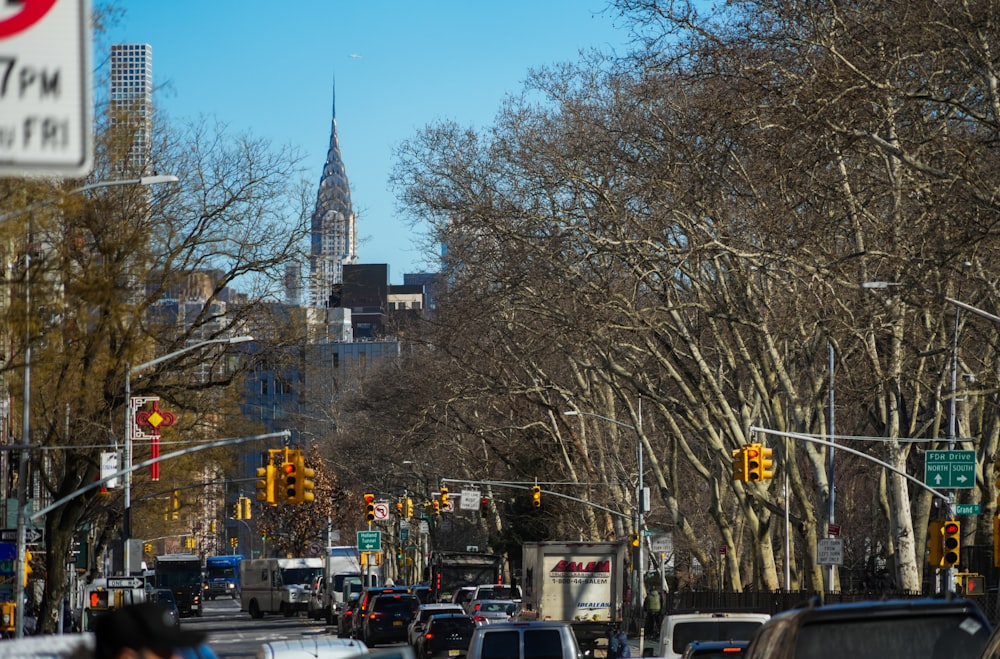 a city street filled with lots of traffic next to tall buildings