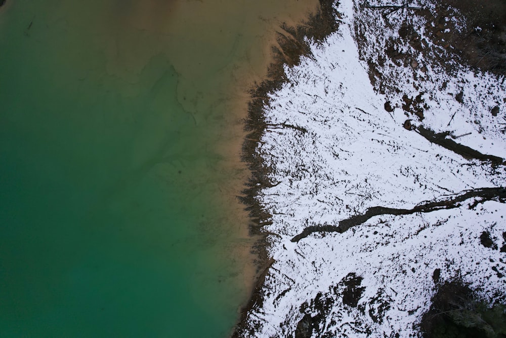 an aerial view of a body of water in the snow