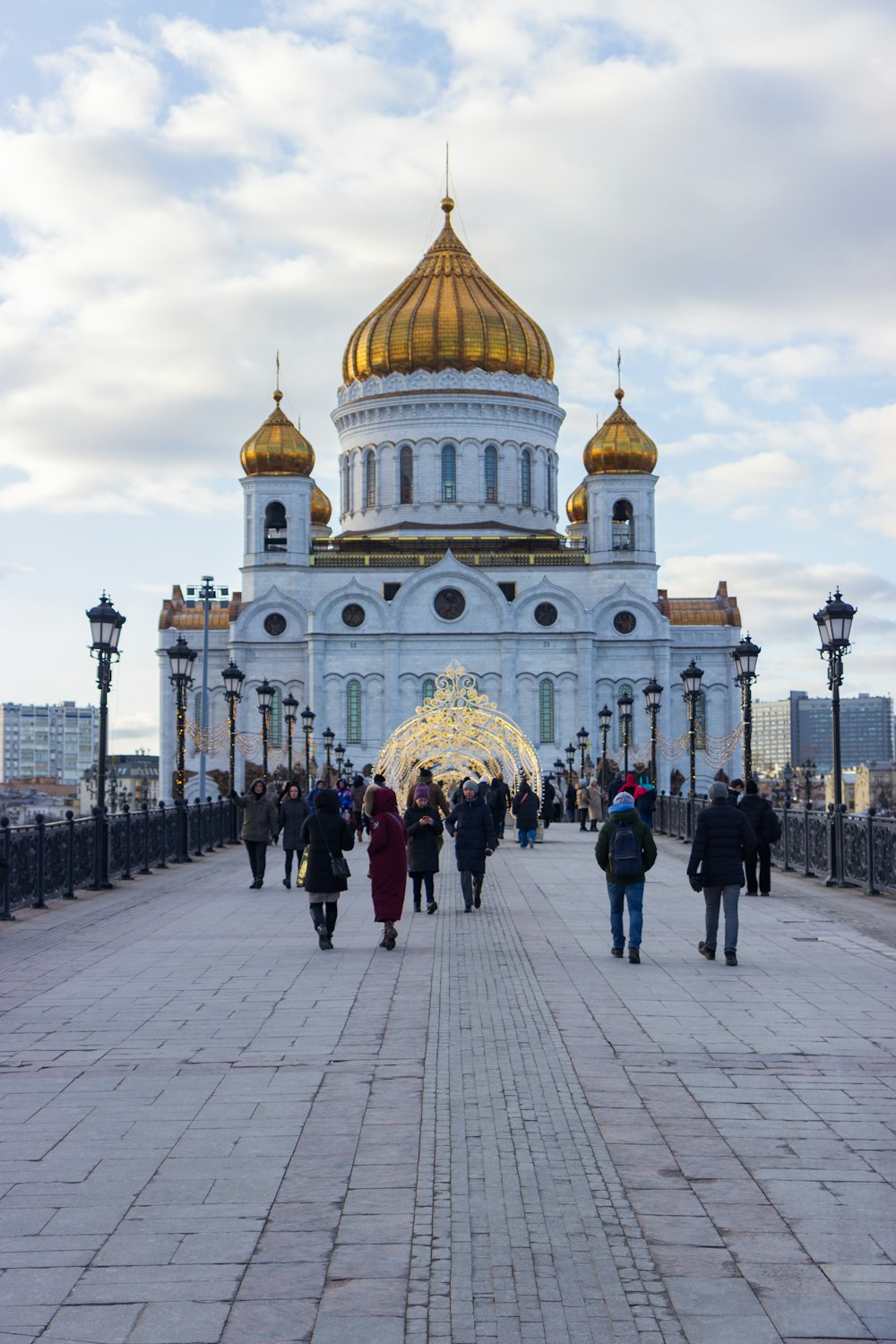 a group of people walking across a bridge