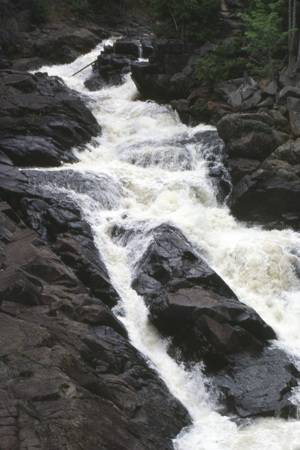 a man riding a surfboard on top of a river