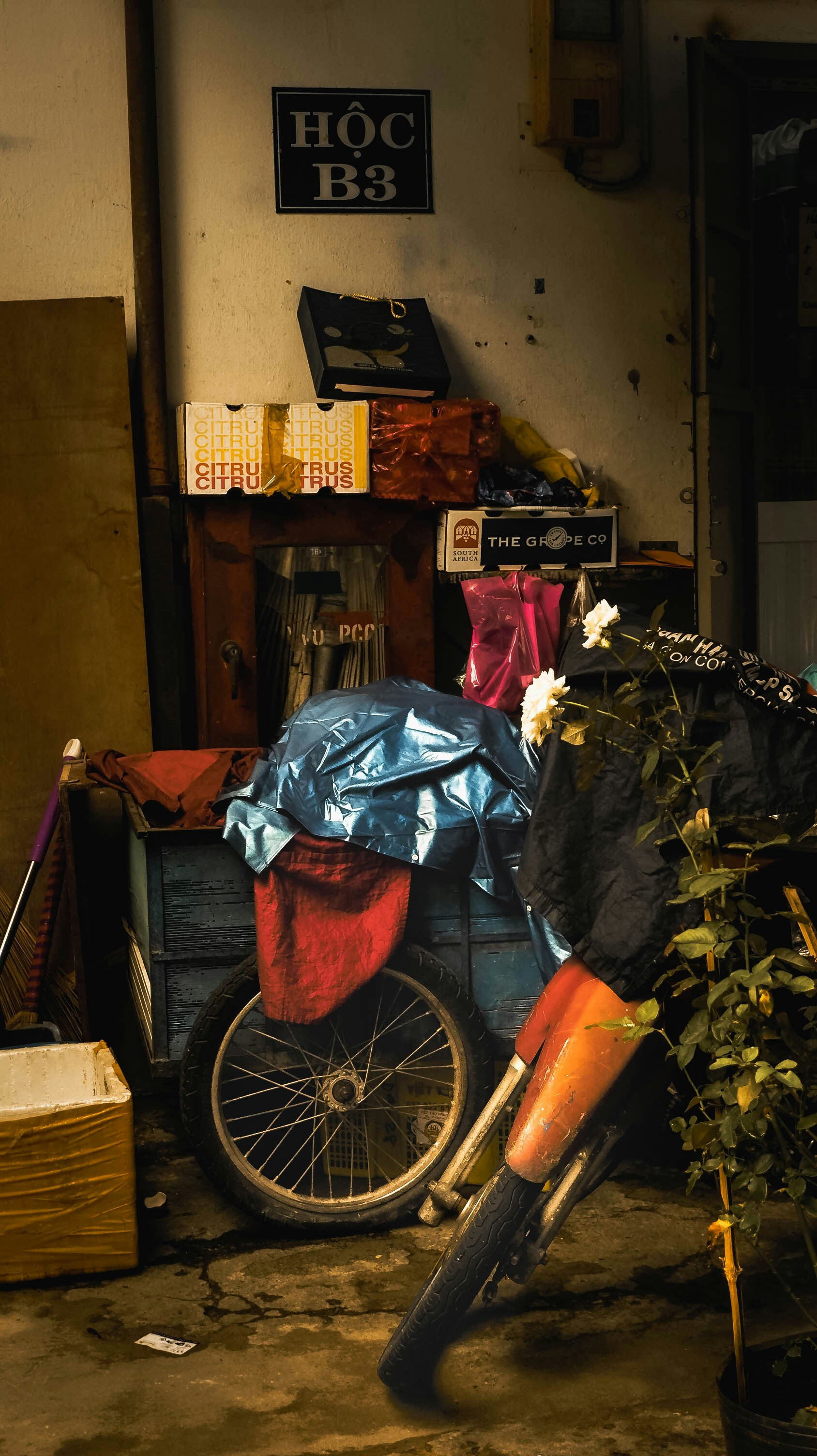 a bicycle parked next to a pile of garbage