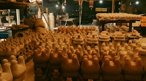 a room filled with lots of pottery pots