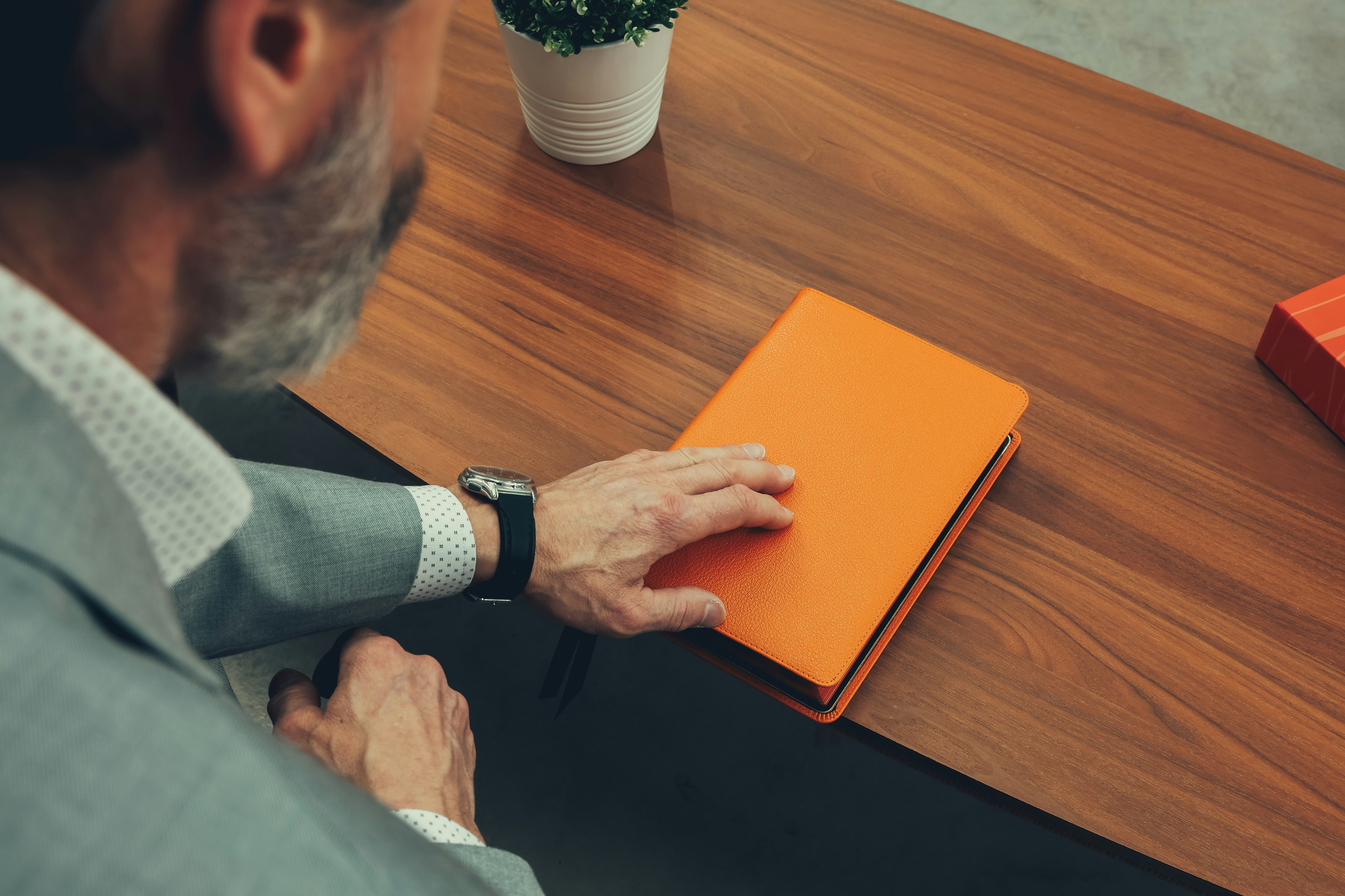 A man sitting at a table with a notebook in front of him