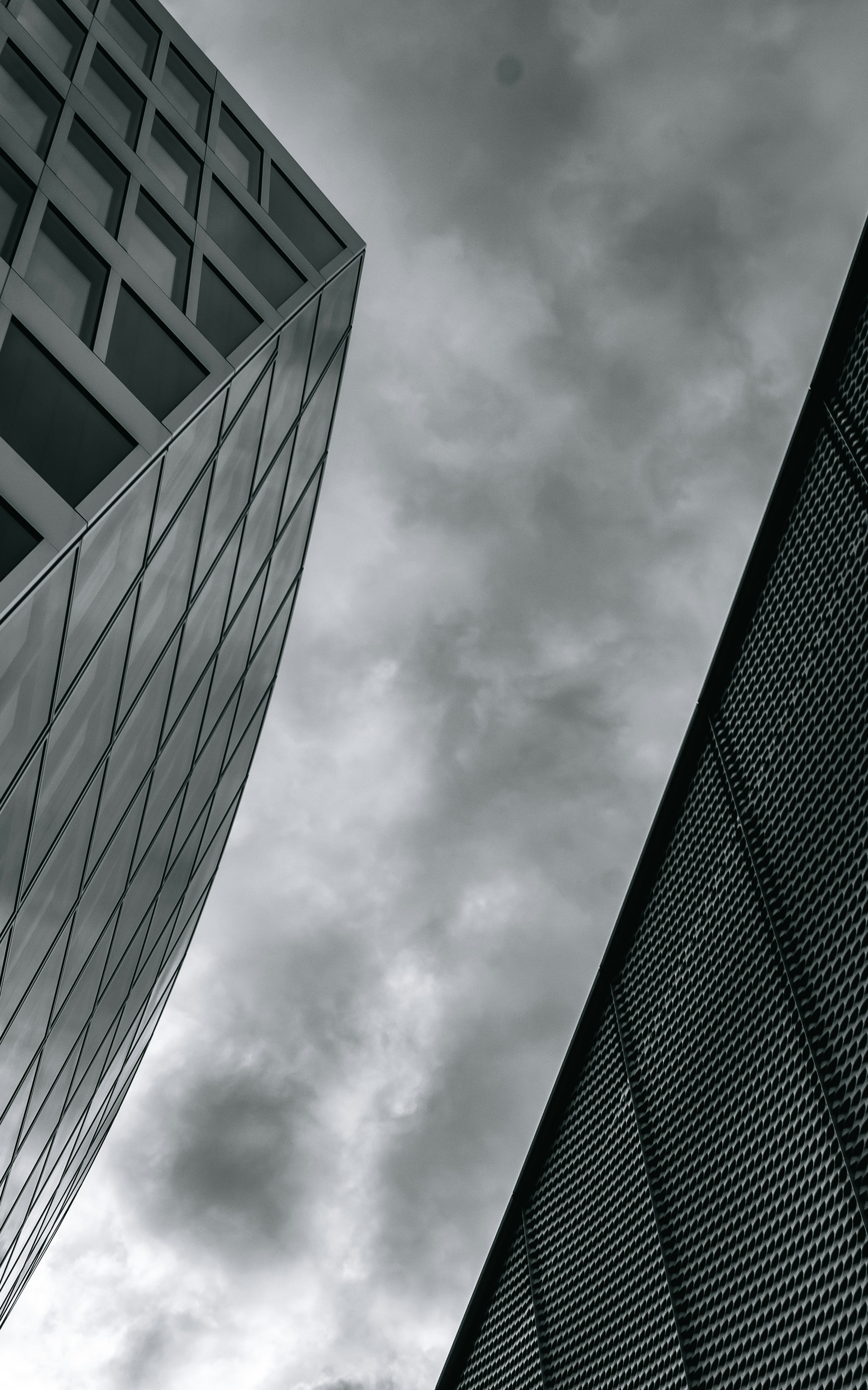 a black and white photo of two tall buildings