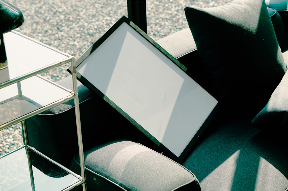 a picture frame sitting on top of a couch