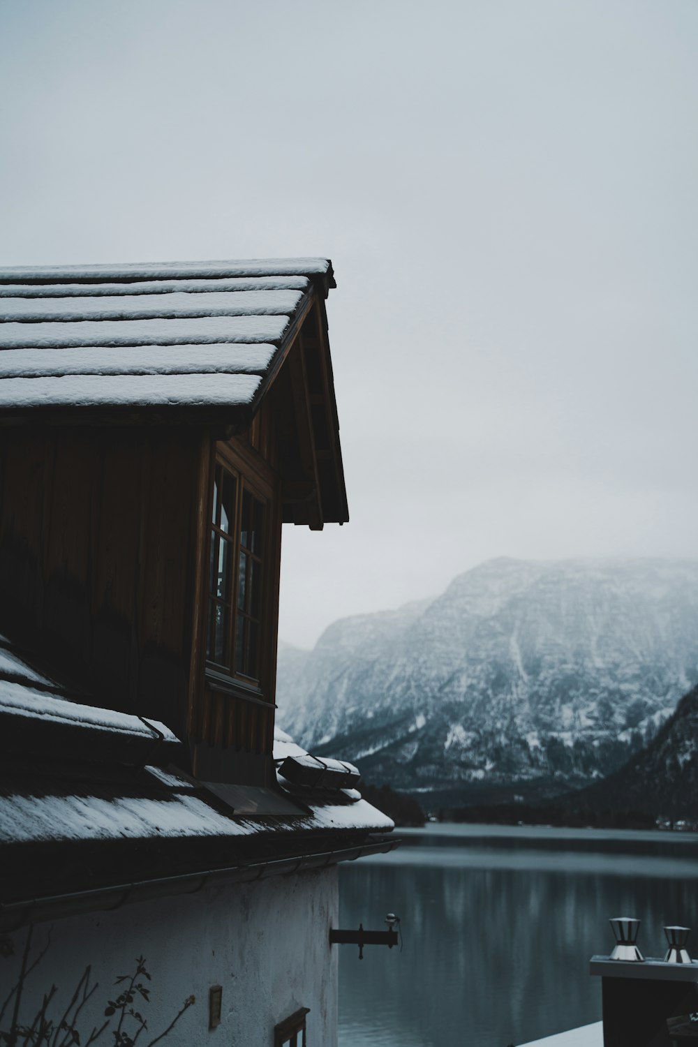 a house sitting on top of a snow covered hillside