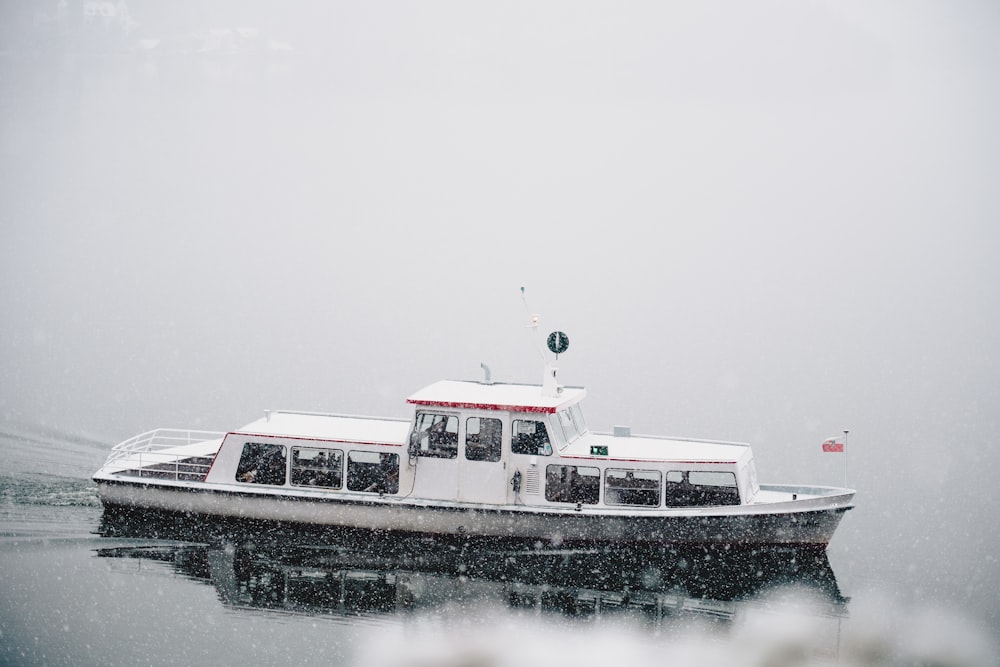 a white boat floating on top of a body of water