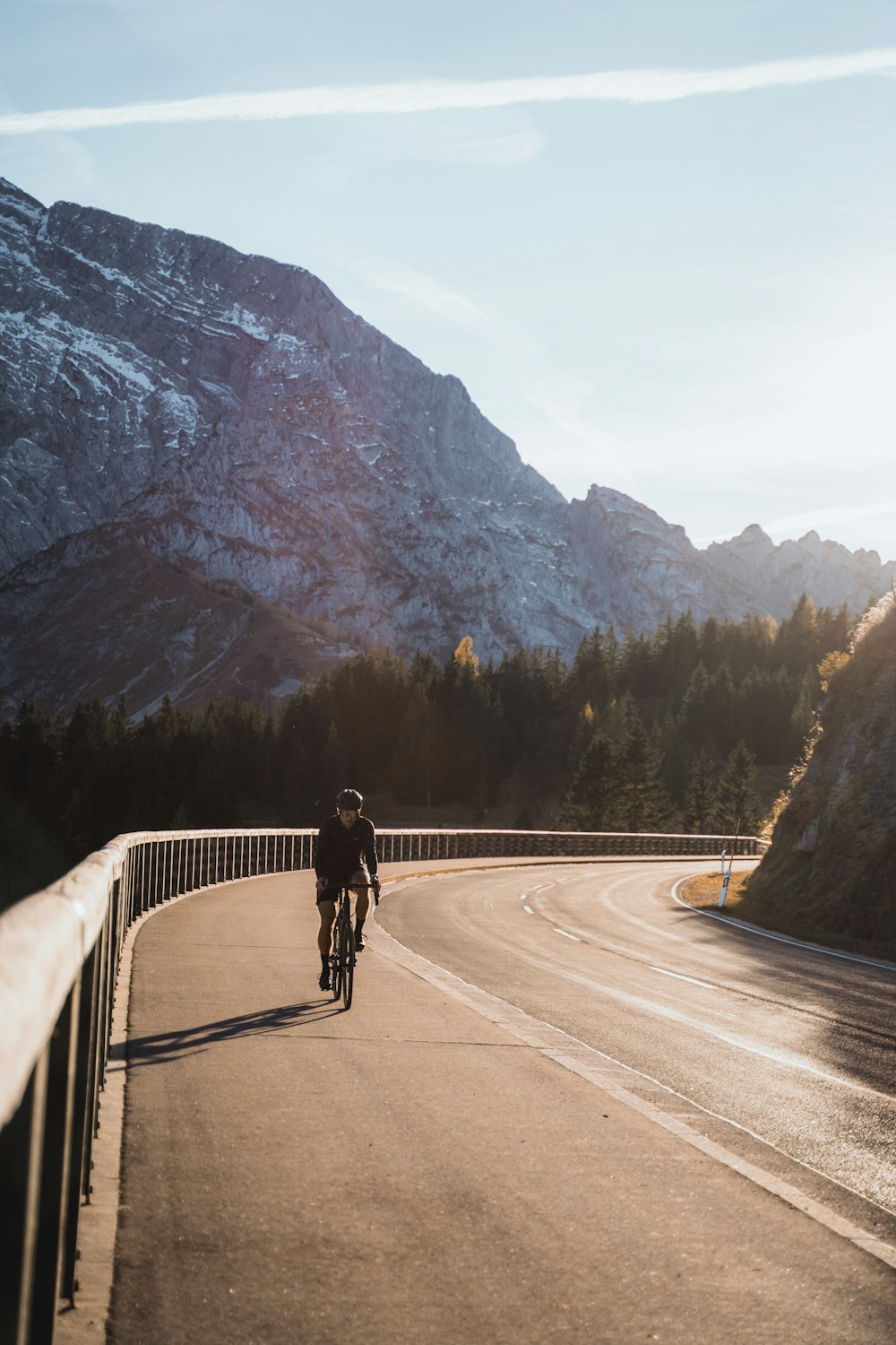 a person riding a bike down a road