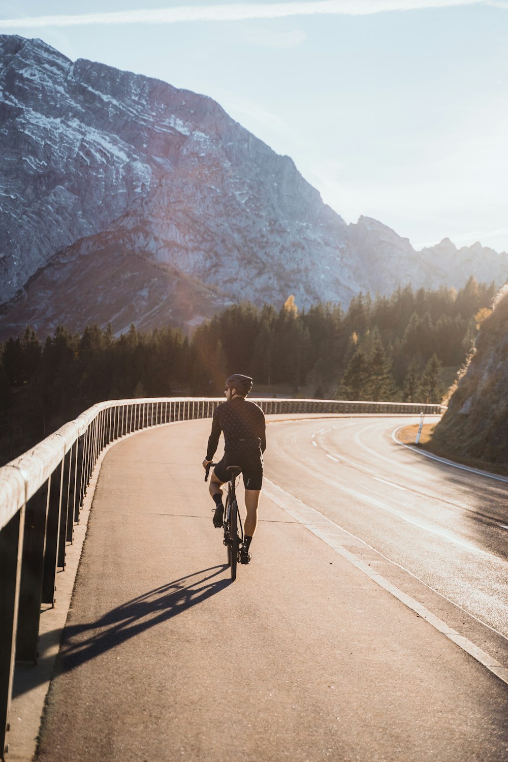 a person riding a bike down a road