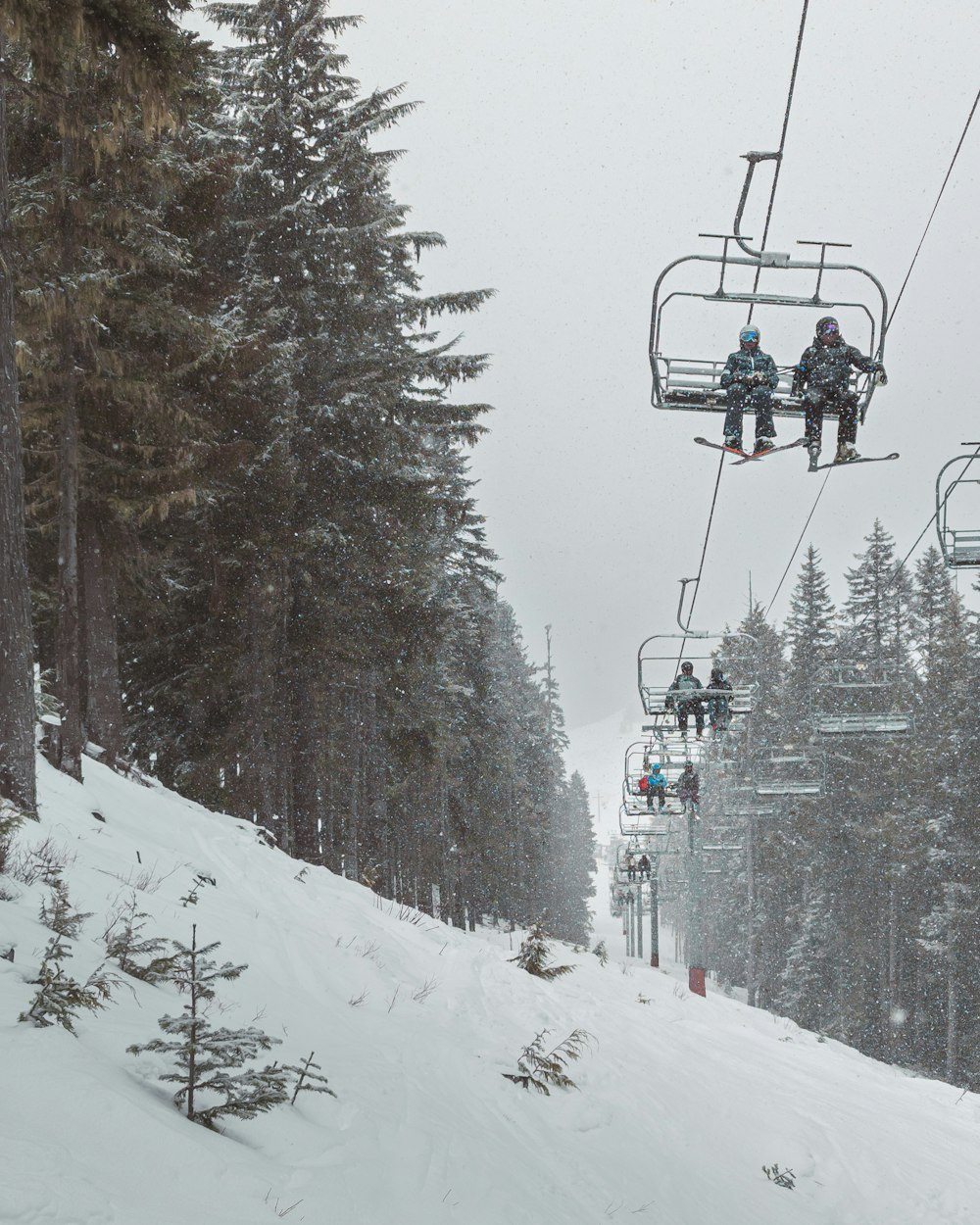 a couple of people riding a ski lift