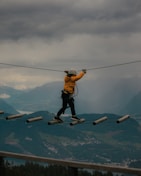 a man is walking across a tight rope