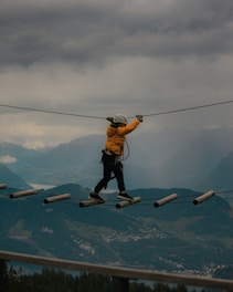 a man is walking across a tight rope