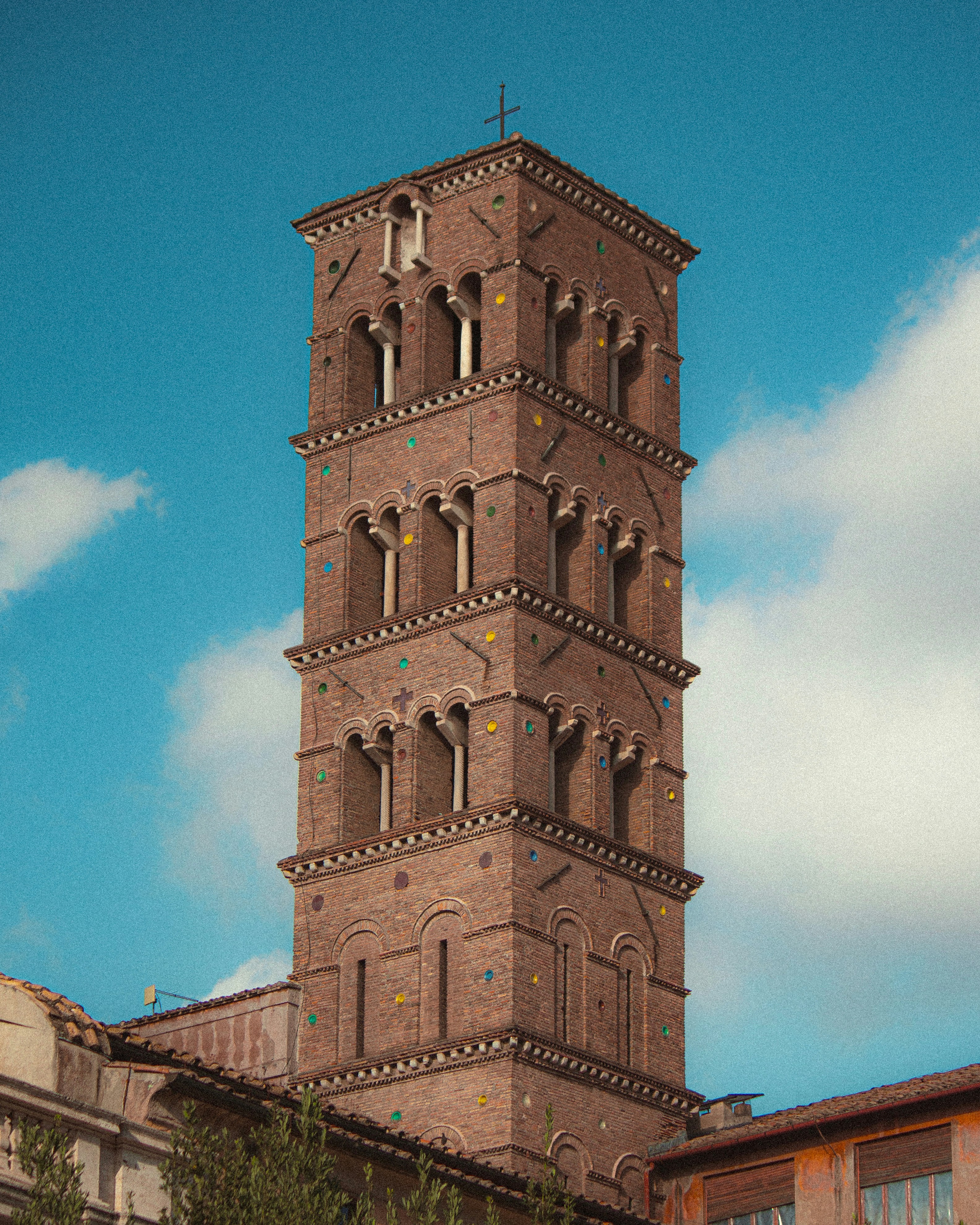 a very tall brick tower with a clock on it's side