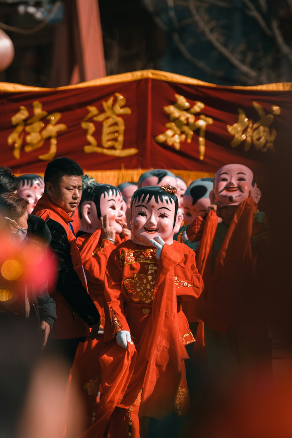 a group of people dressed in orange and wearing masks