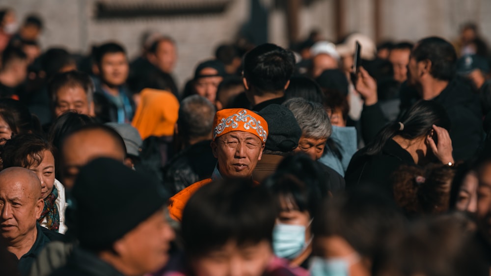 a large group of people standing around each other