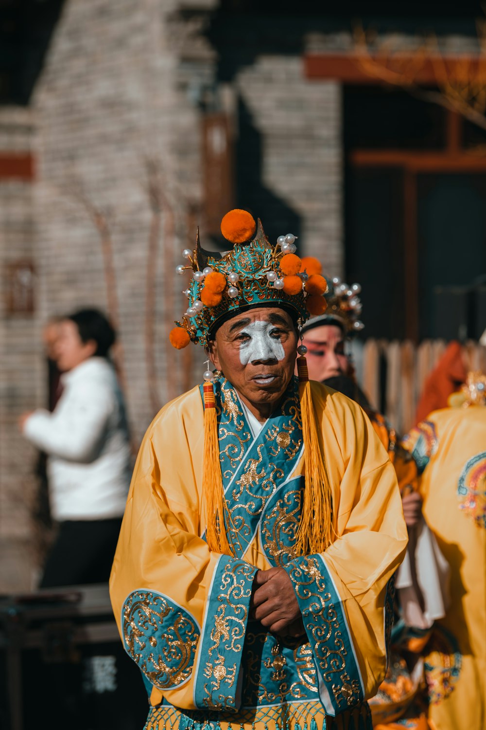 a man with a painted face standing in front of other people