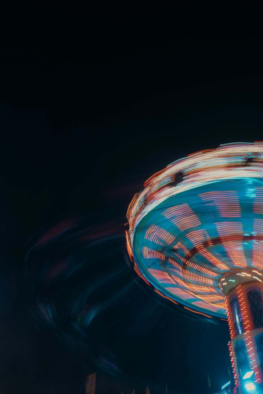 a carnival ride at night with a blurry background
