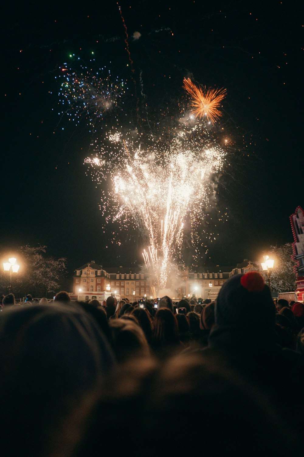 a crowd of people watching a fireworks display