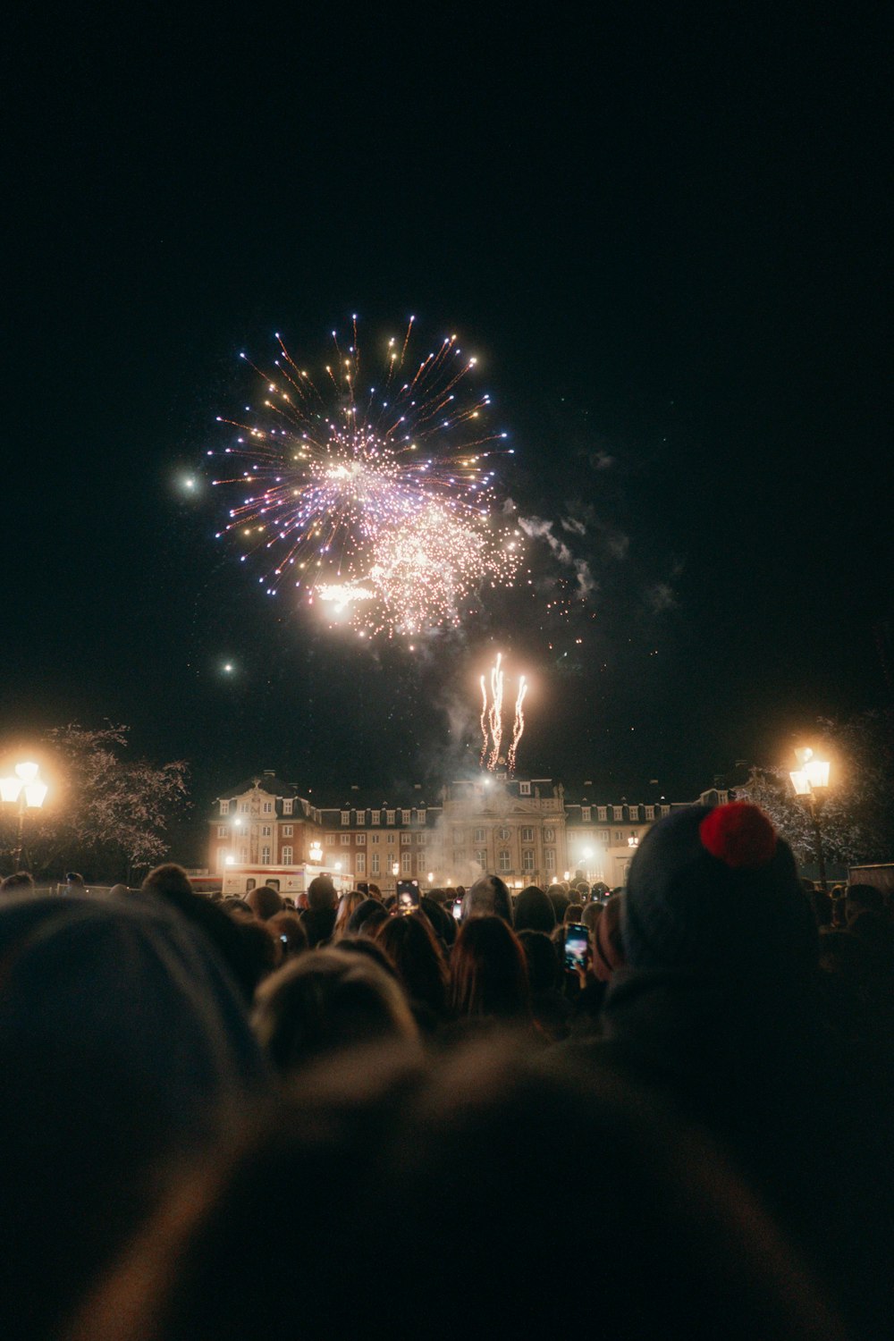 a crowd of people watching a fireworks display