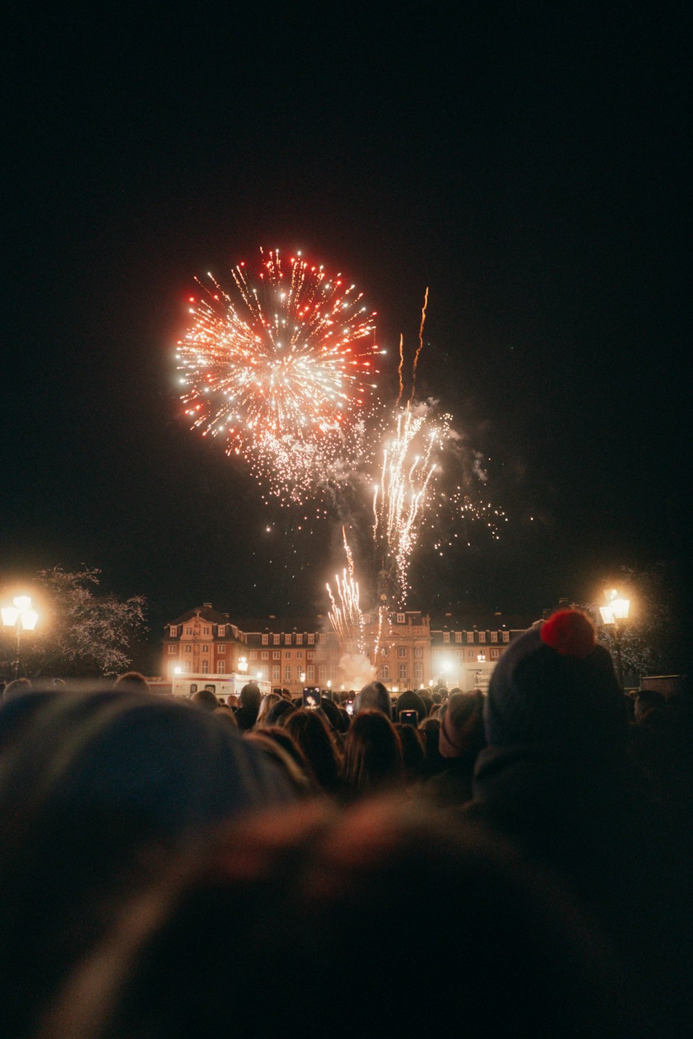 a crowd of people watching a fireworks display