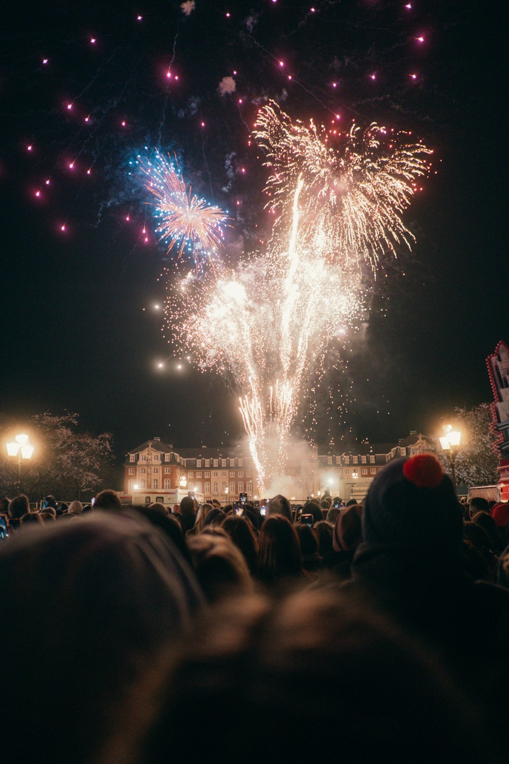 a crowd of people watching a fireworks display