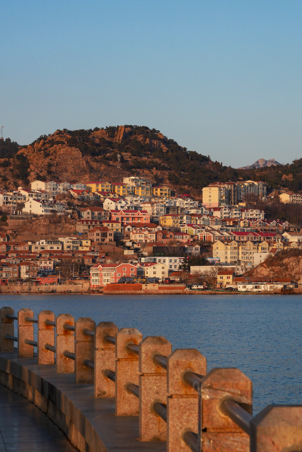 a body of water with a city in the background