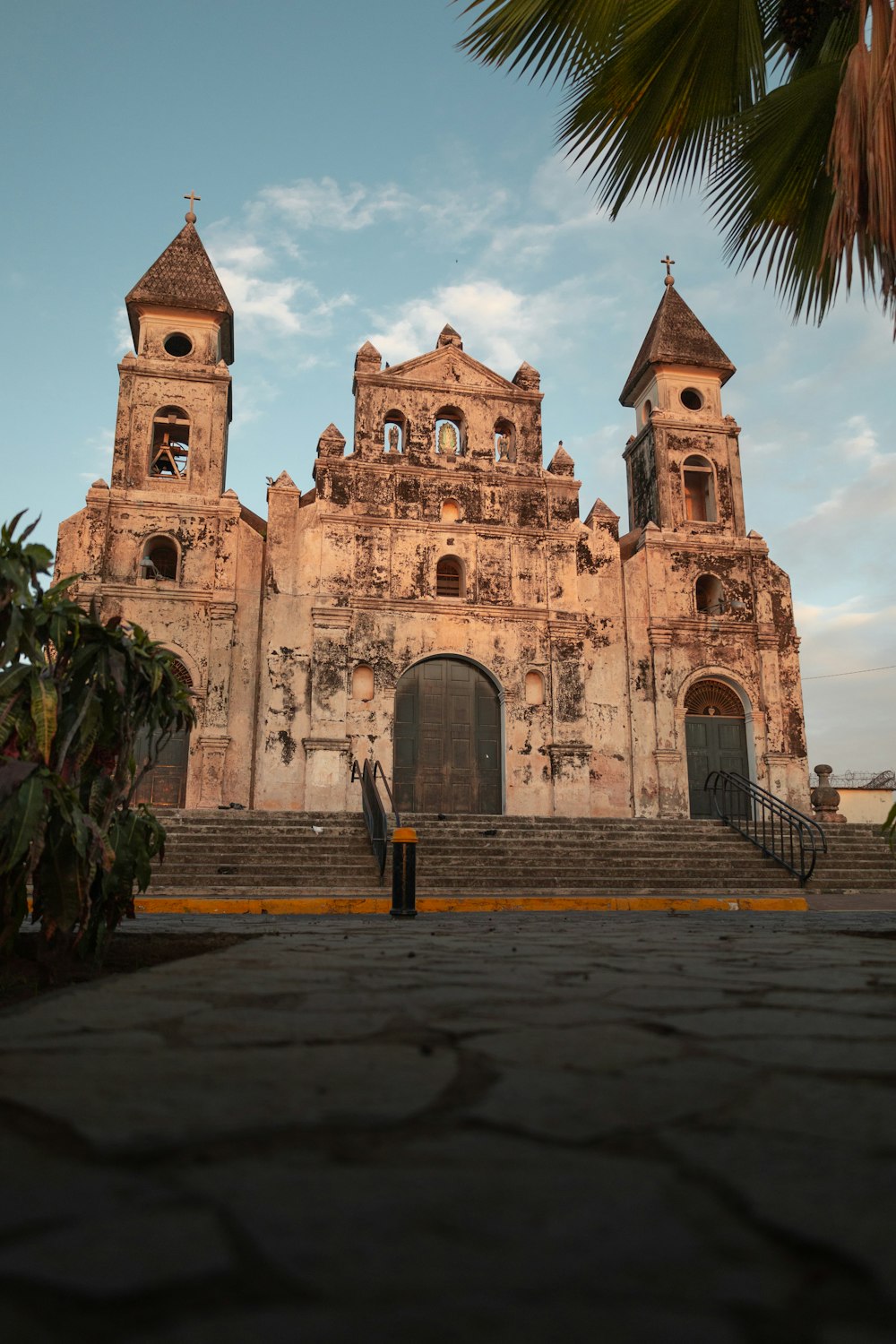 a large building with two towers and a man standing in front of it