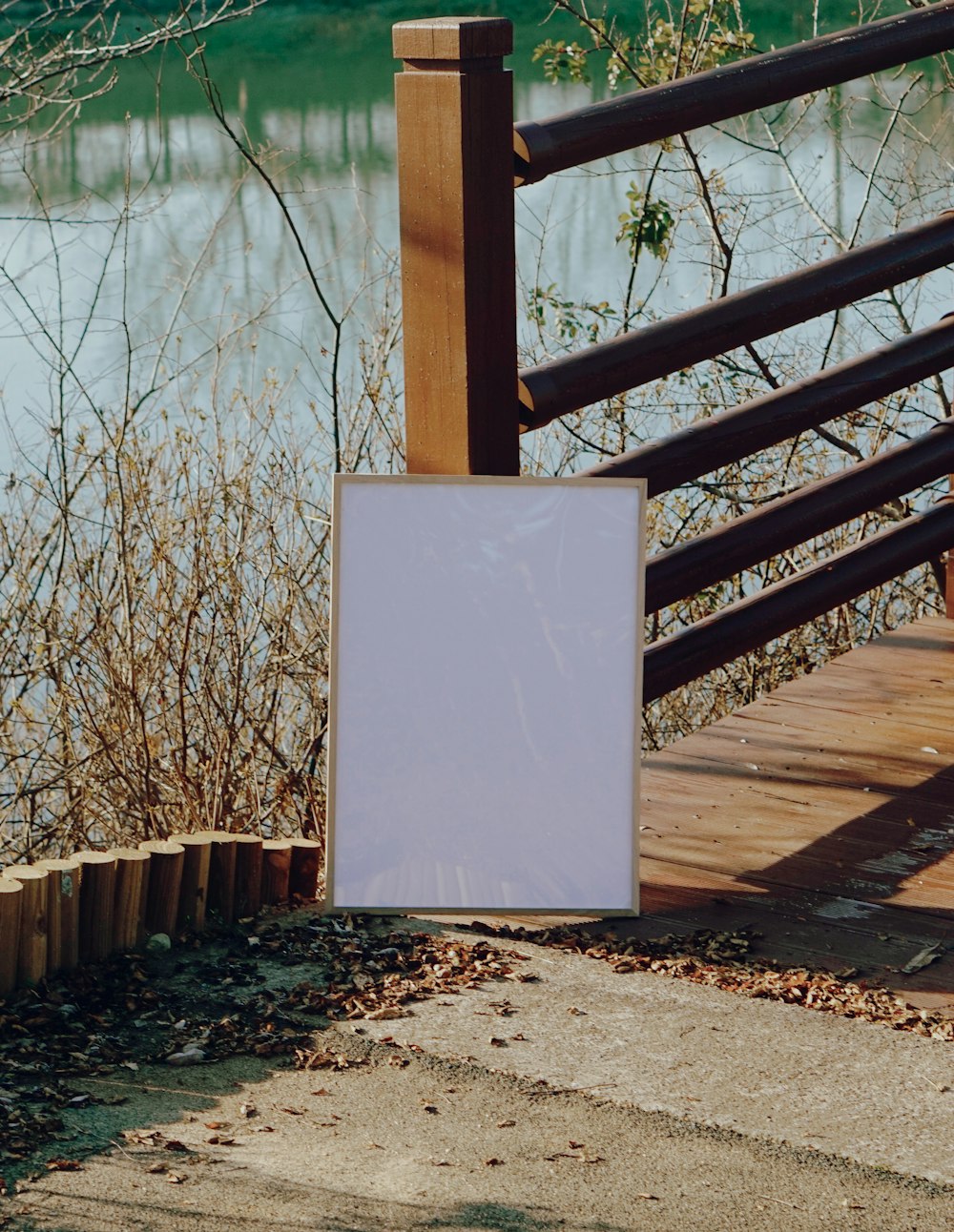 a white sign sitting on the side of a wooden bridge