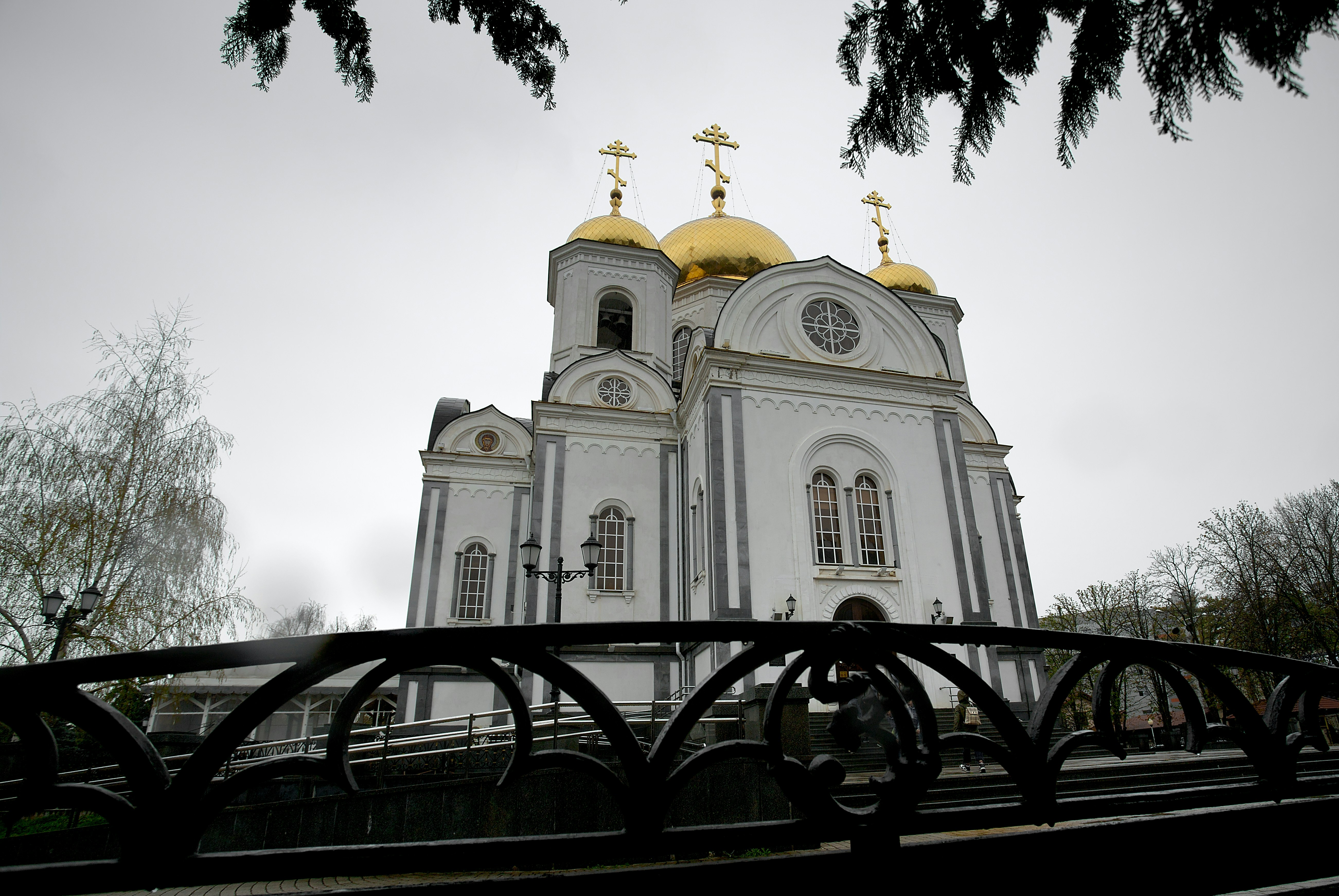 a large white church with gold domes on top of it