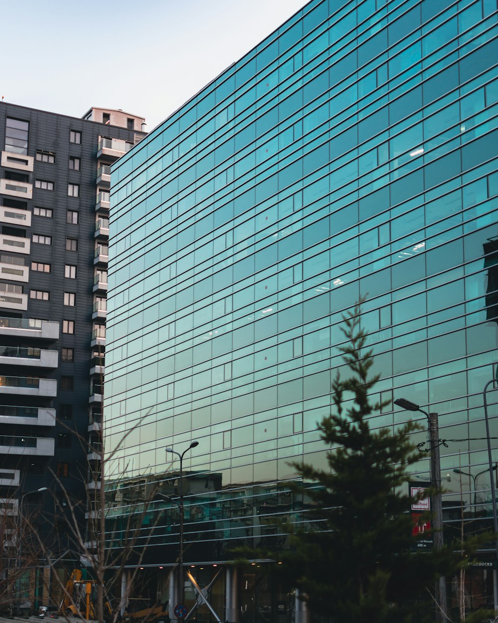 a large building with a lot of windows next to a street