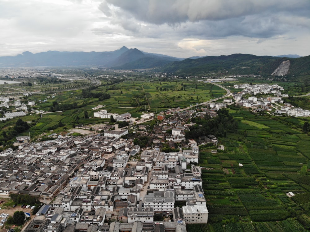 an aerial view of a city with mountains in the background