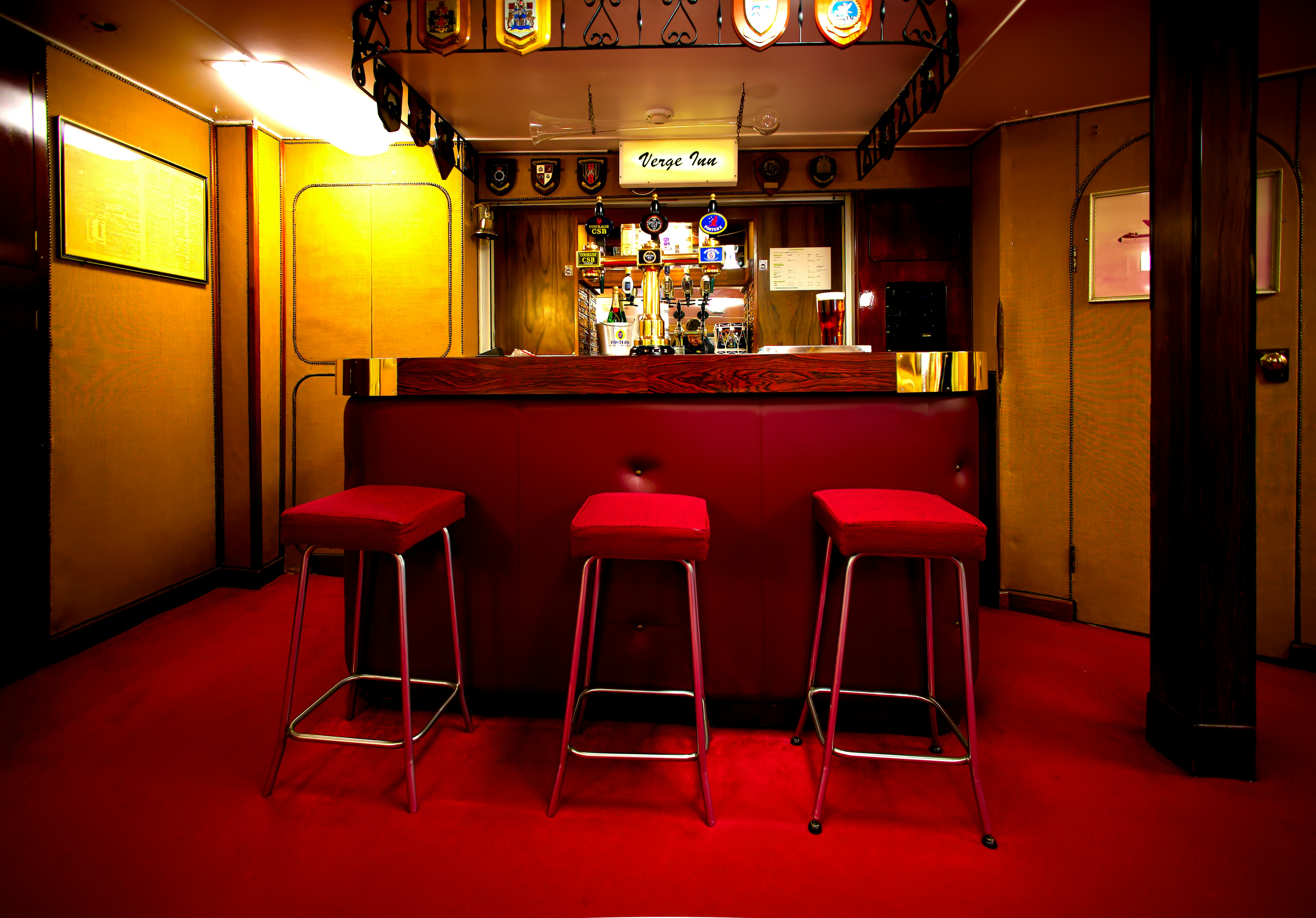 Busy bar and restaurant interior with happy patrons, warm wood tones, and glowing beer taps