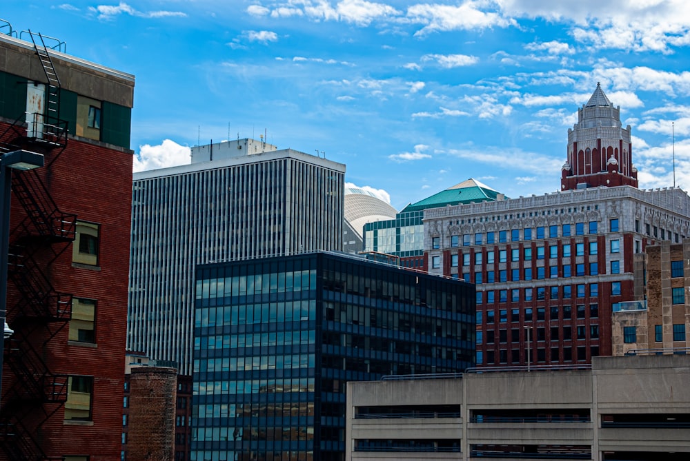 a group of buildings with a clock tower in the background