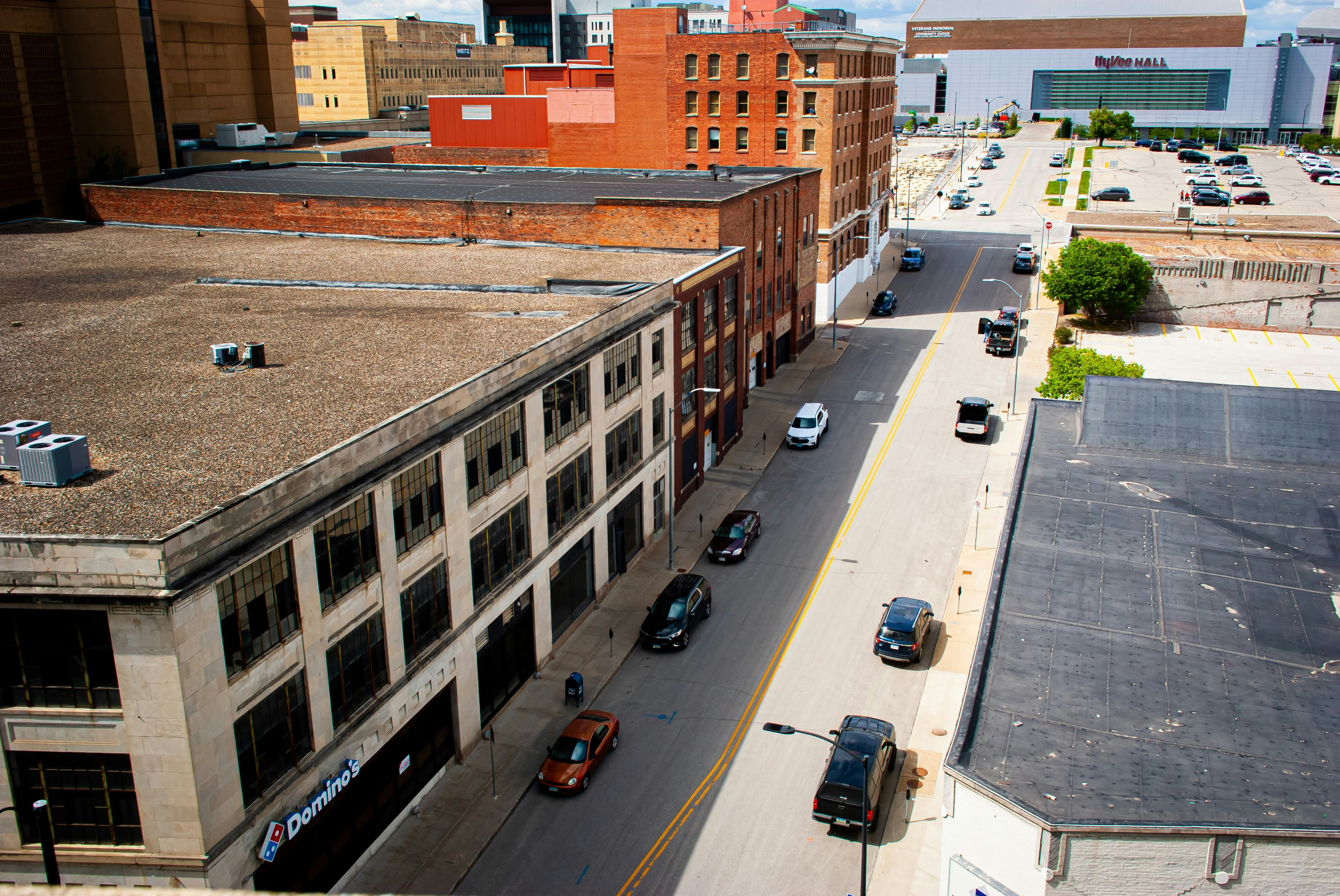 a city street filled with lots of traffic next to tall buildings