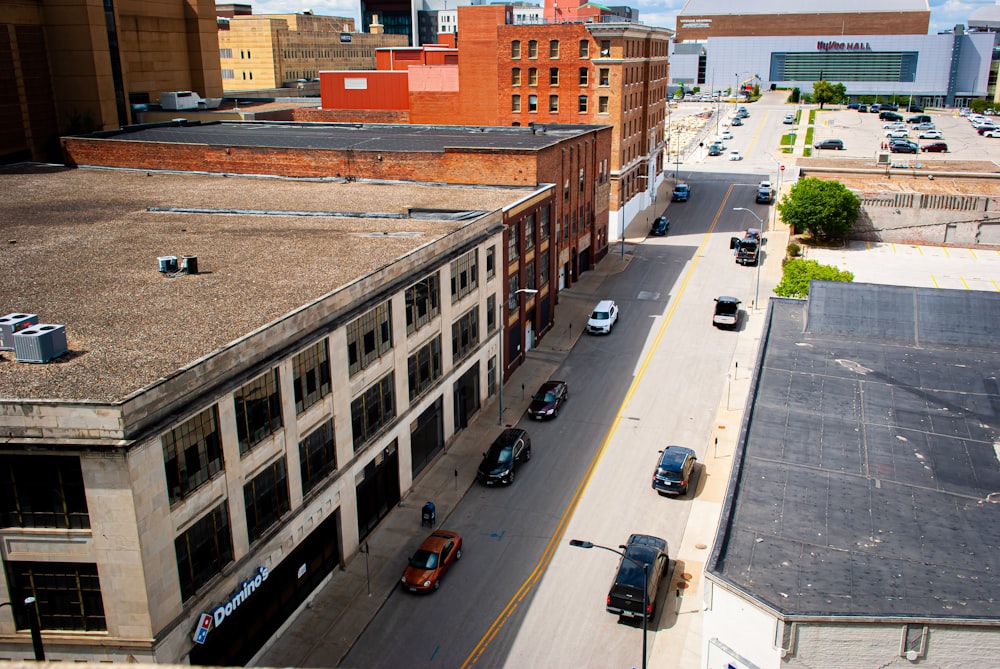 a city street filled with lots of traffic next to tall buildings