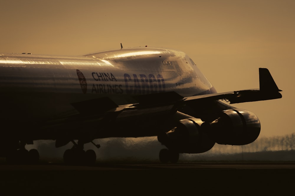 a large jetliner sitting on top of an airport runway