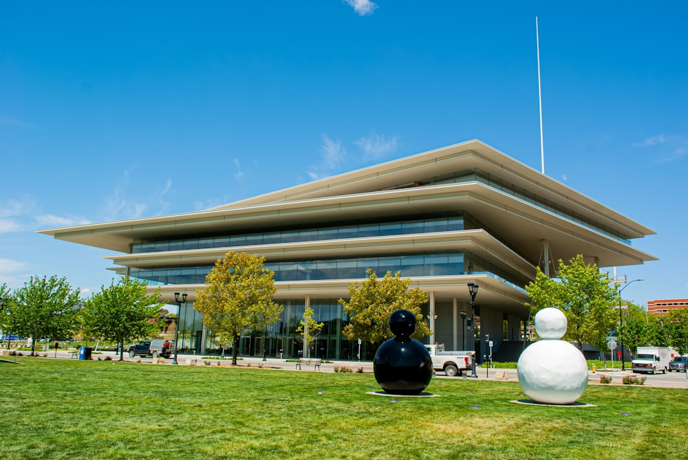 a large building with two sculptures in front of it