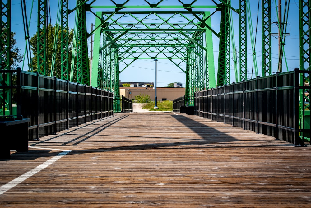 a bridge that has a green metal structure on top of it