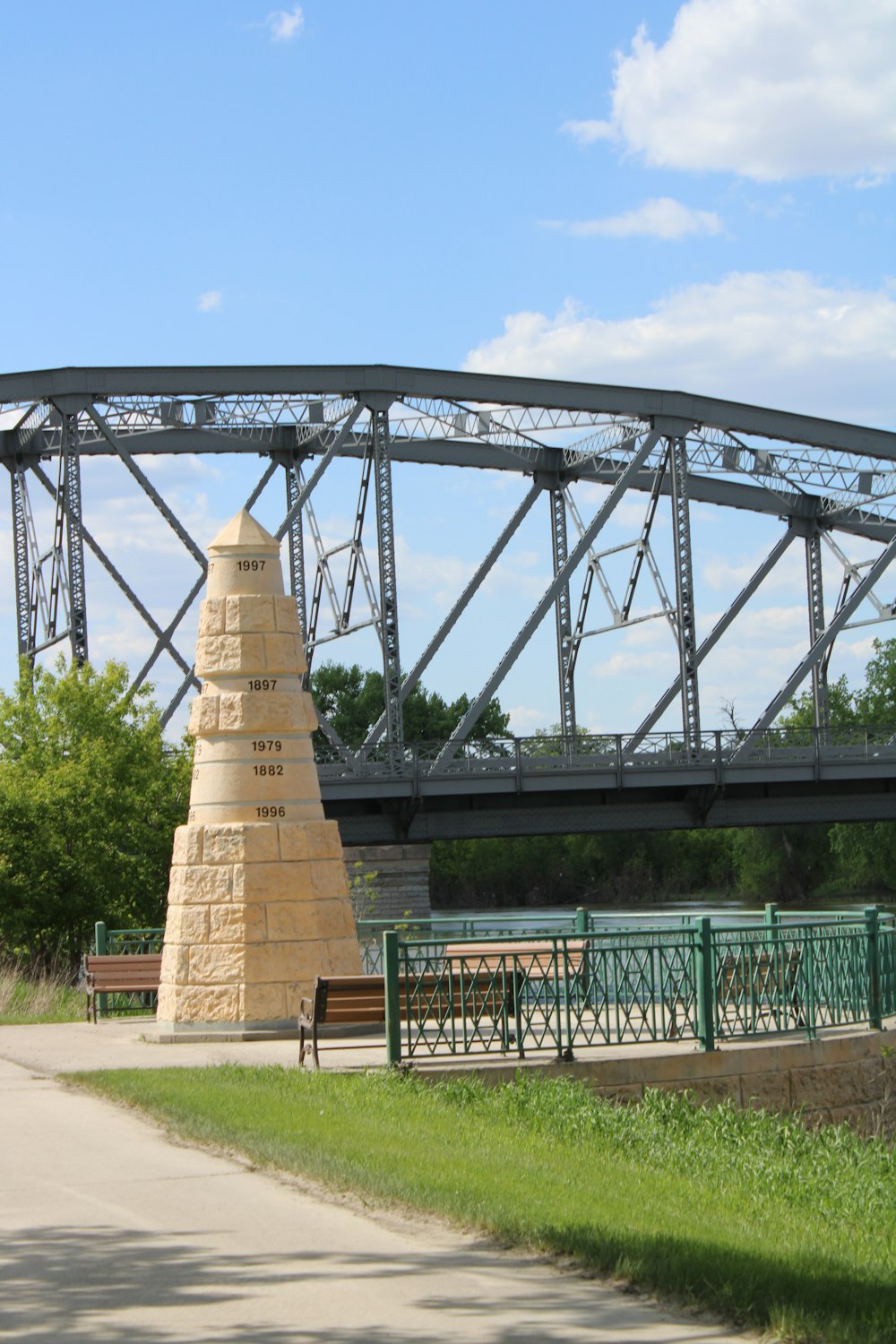 a bridge over a river with benches and a bench