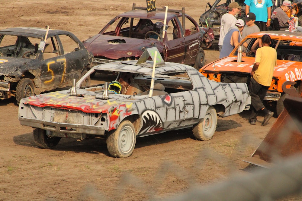 a group of people standing around a wrecked car