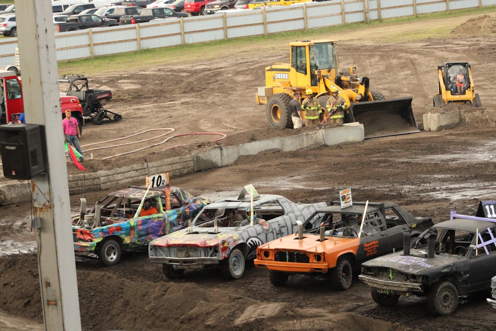 a group of cars that are parked in the dirt