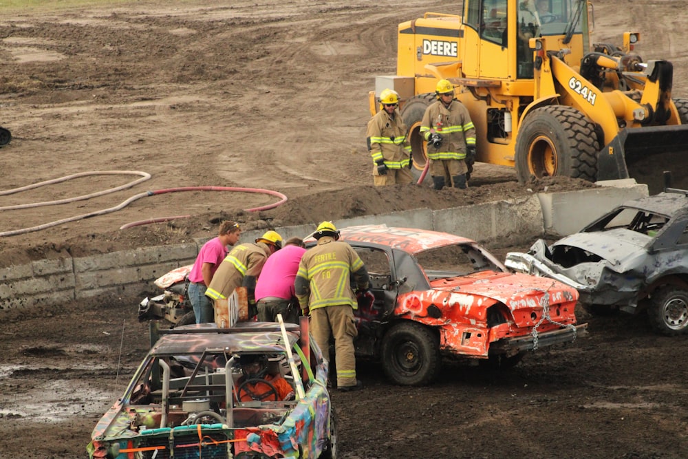 a group of people standing around a wrecked car