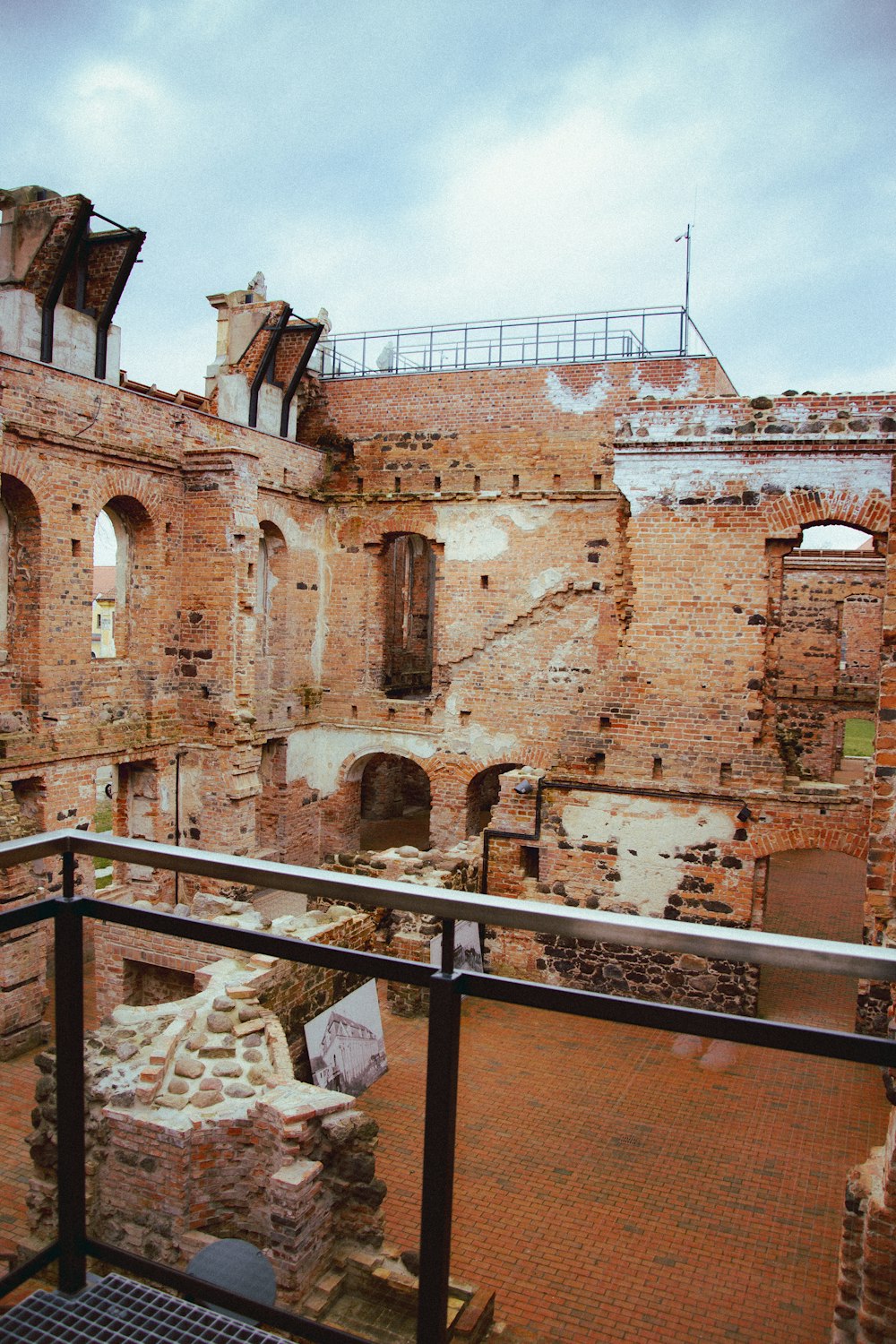 a balcony view of an old building with brick walls