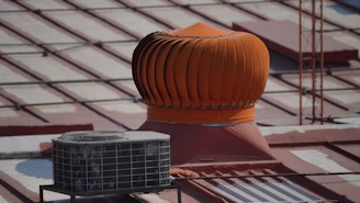 a roof ventilator on top of a building under construction